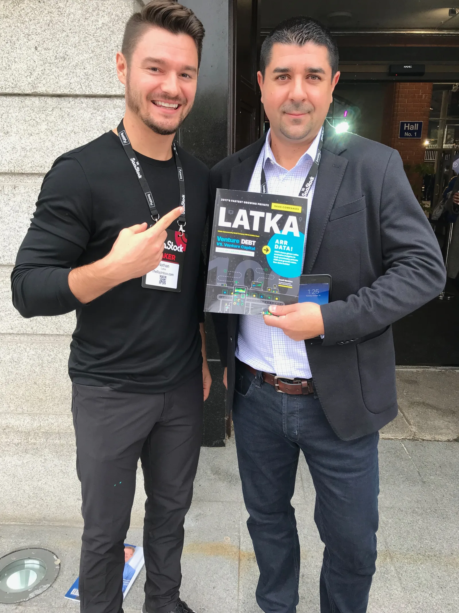 Live at SaaStock Europe 2018 — Nathan Latka with an attendee holding the LATKA Magazine outside Hall No. 1 at RDS Simmonscourt
