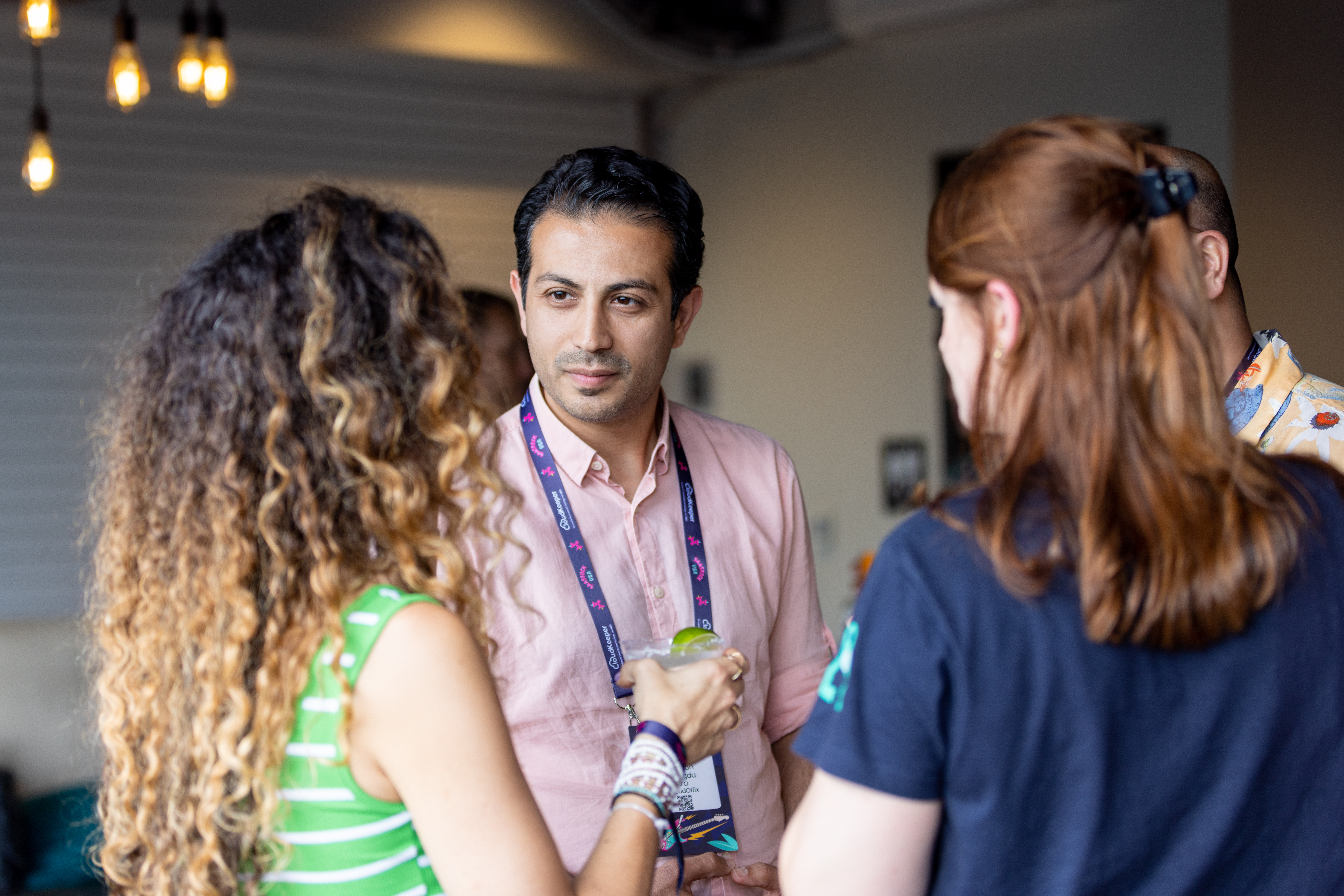 Photograph of three people networking at SaaStock USA