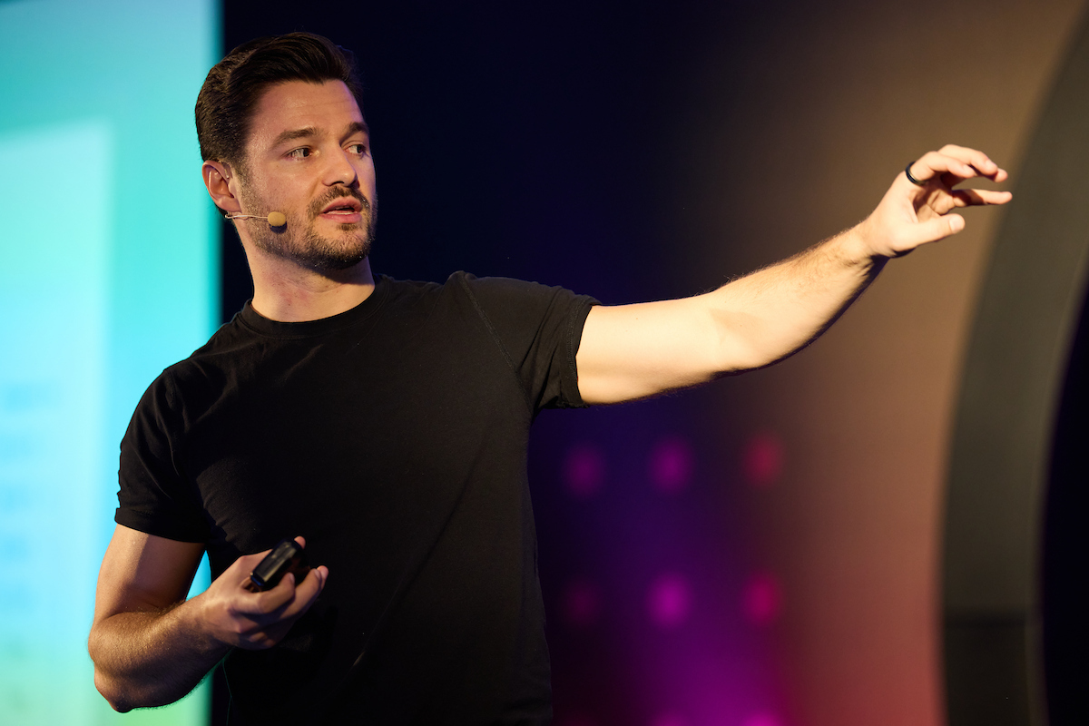 Nathan Latka on stage at SaaStock